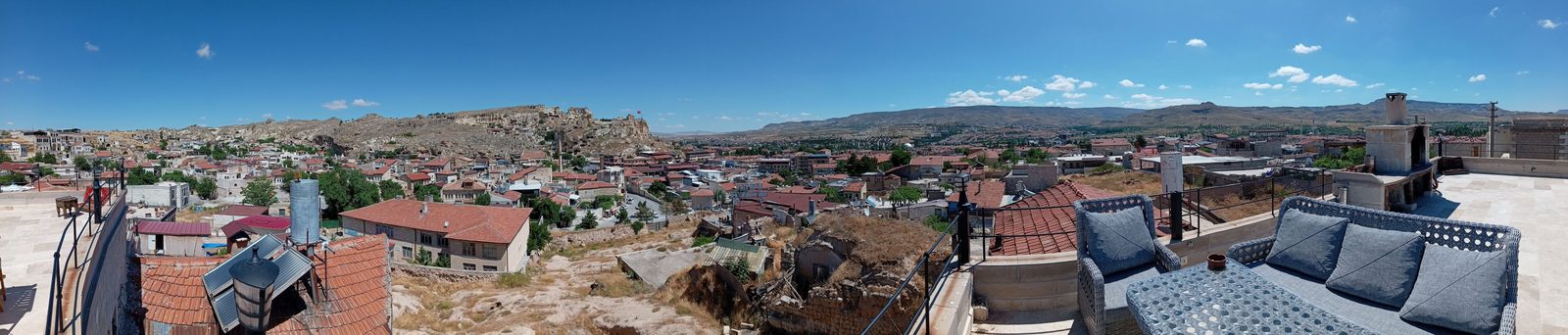 Rooftops of a village with mountains in the distance